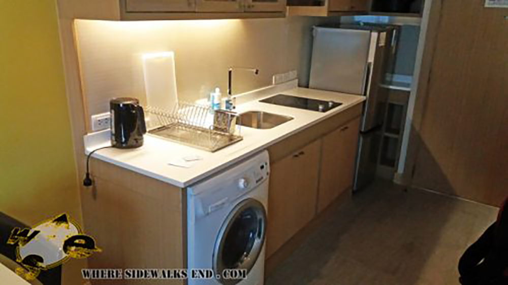 Kitchen with laundry machine at at Somerset Lake Point Hotel in Bangkok for Digital Nomads