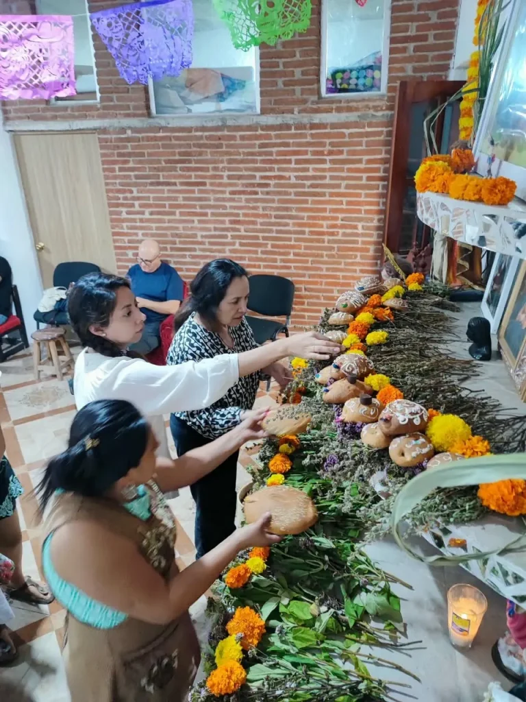Oaxaca Day of the Dead - Teotitlan del Valle - Small group tour - teotitlan building an altar with an indigenous family